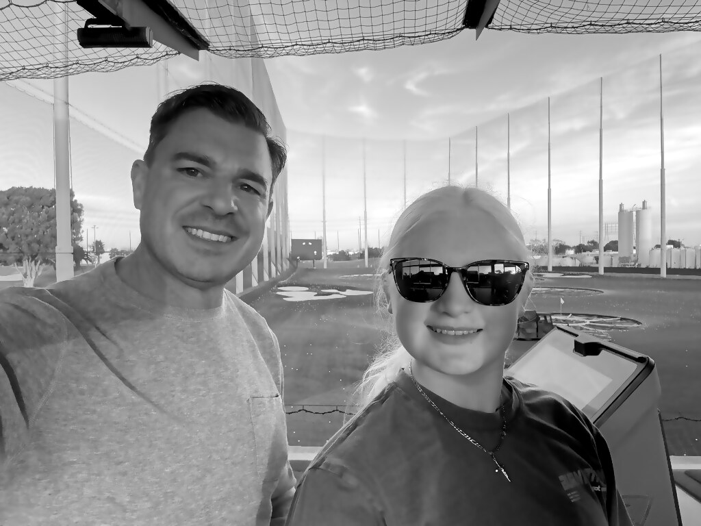 Father-daughter at the driving range